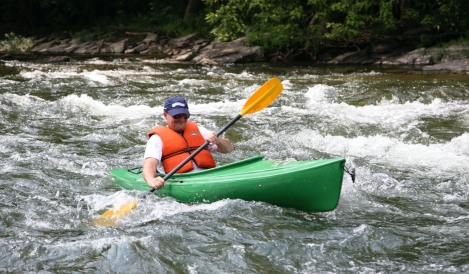 man in kayak navigating the choppy waters Downriver Canoe Company Shenandoah Valley River
